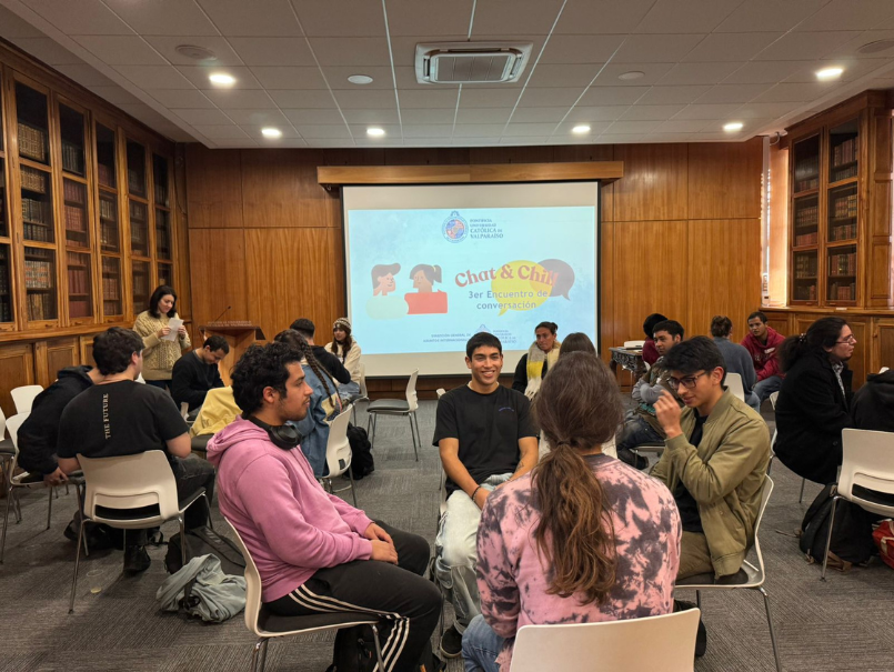 Estudiantes PUCV junto a estudiantes de intercambio, ubicados en grupos conversando en medio de actividad de CELE. 
